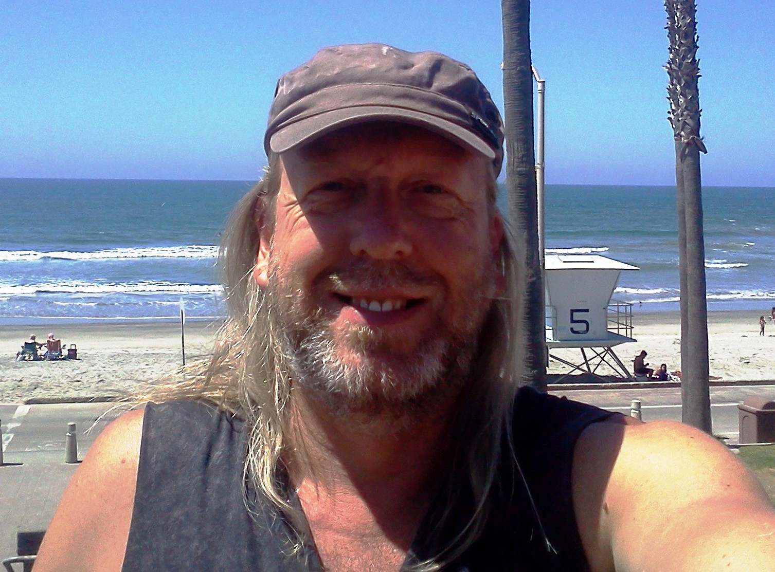 Russ Littau smiling near the beach